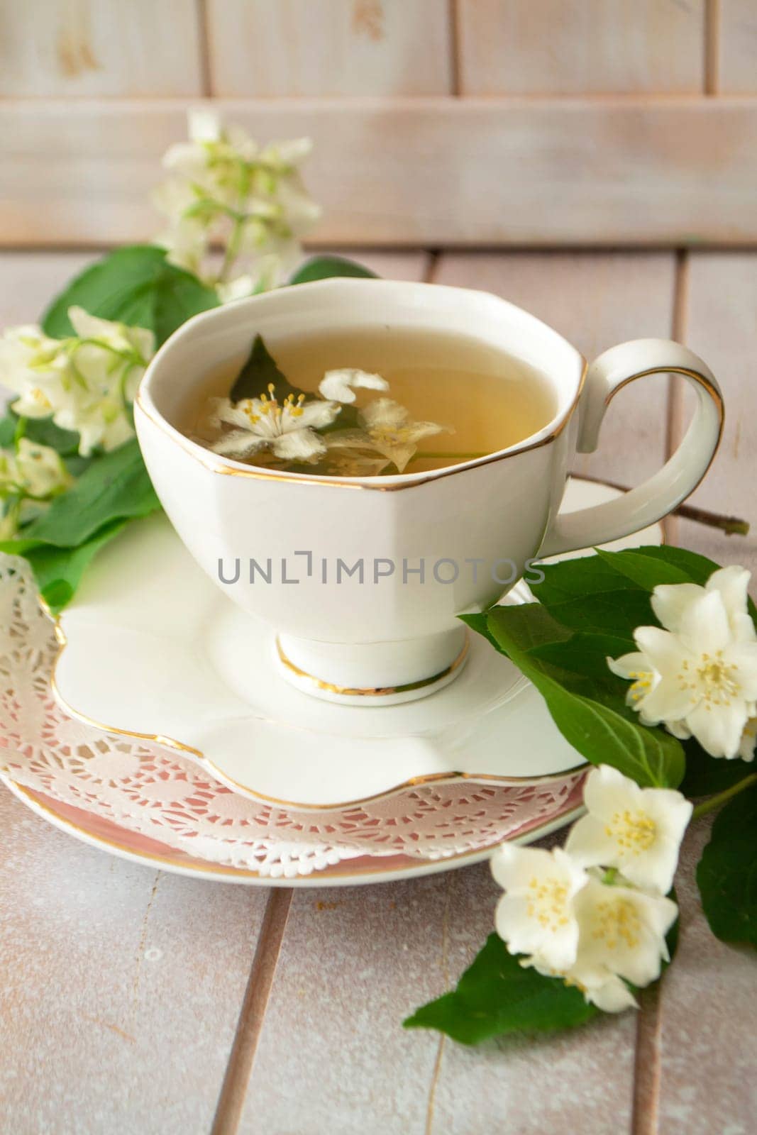 Jasmine herbal tea on a shabby wooden table, vertical image