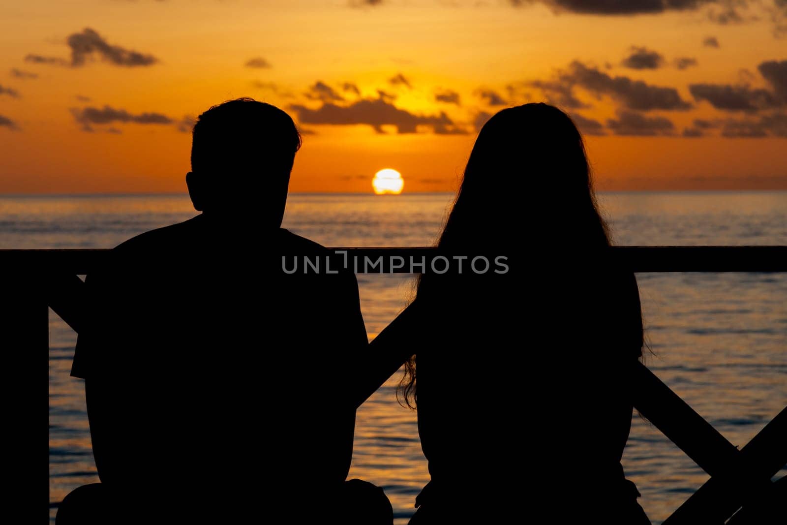 Sunset on the Maldives, a couple on the beach looking in the distance