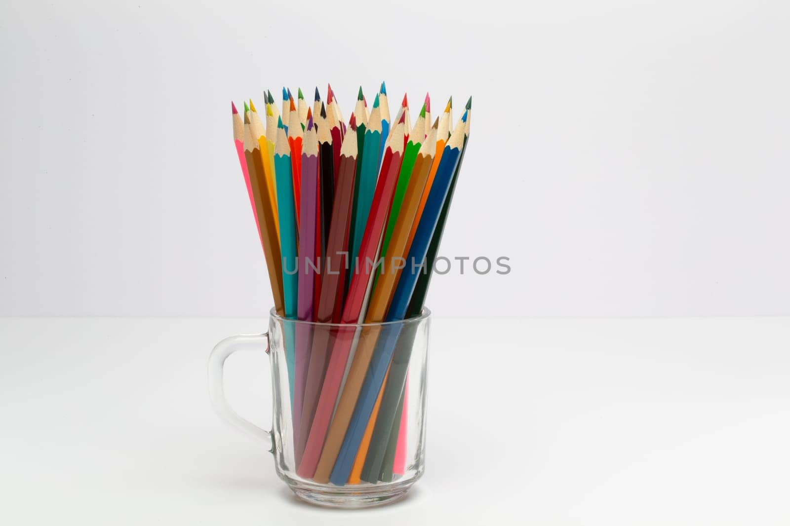 Some colorful wooden pencils on a white background