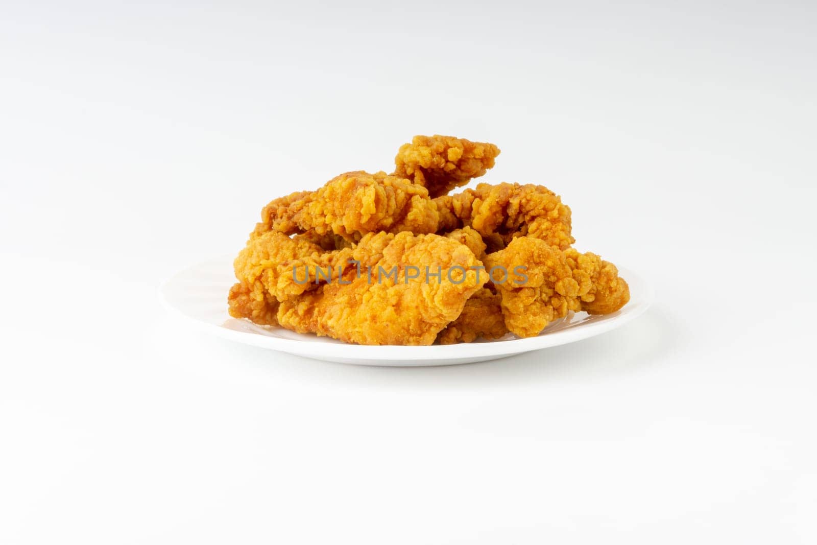 Fried breaded chicken fillet isolated on white background