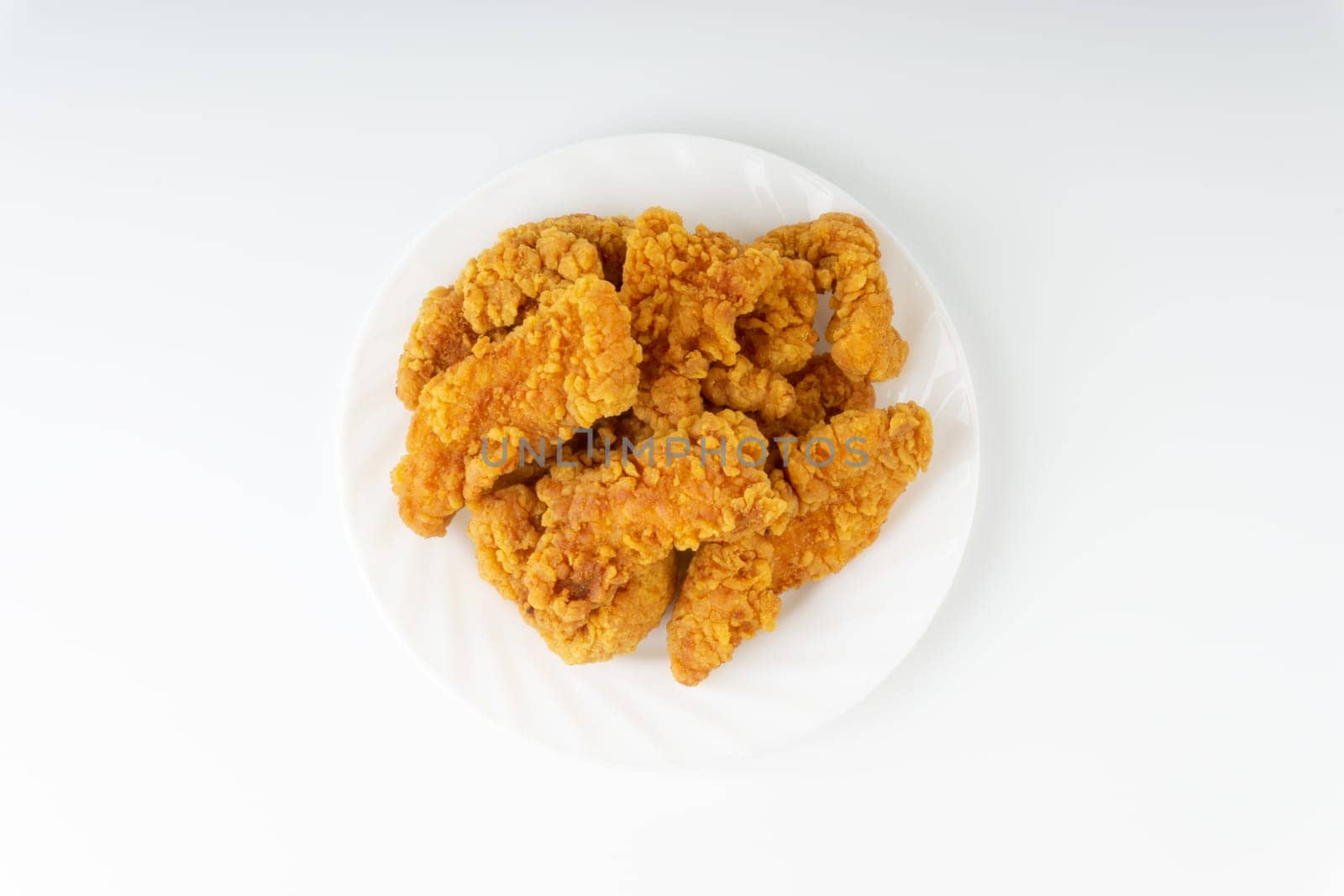 Fried breaded chicken fillet isolated on white background