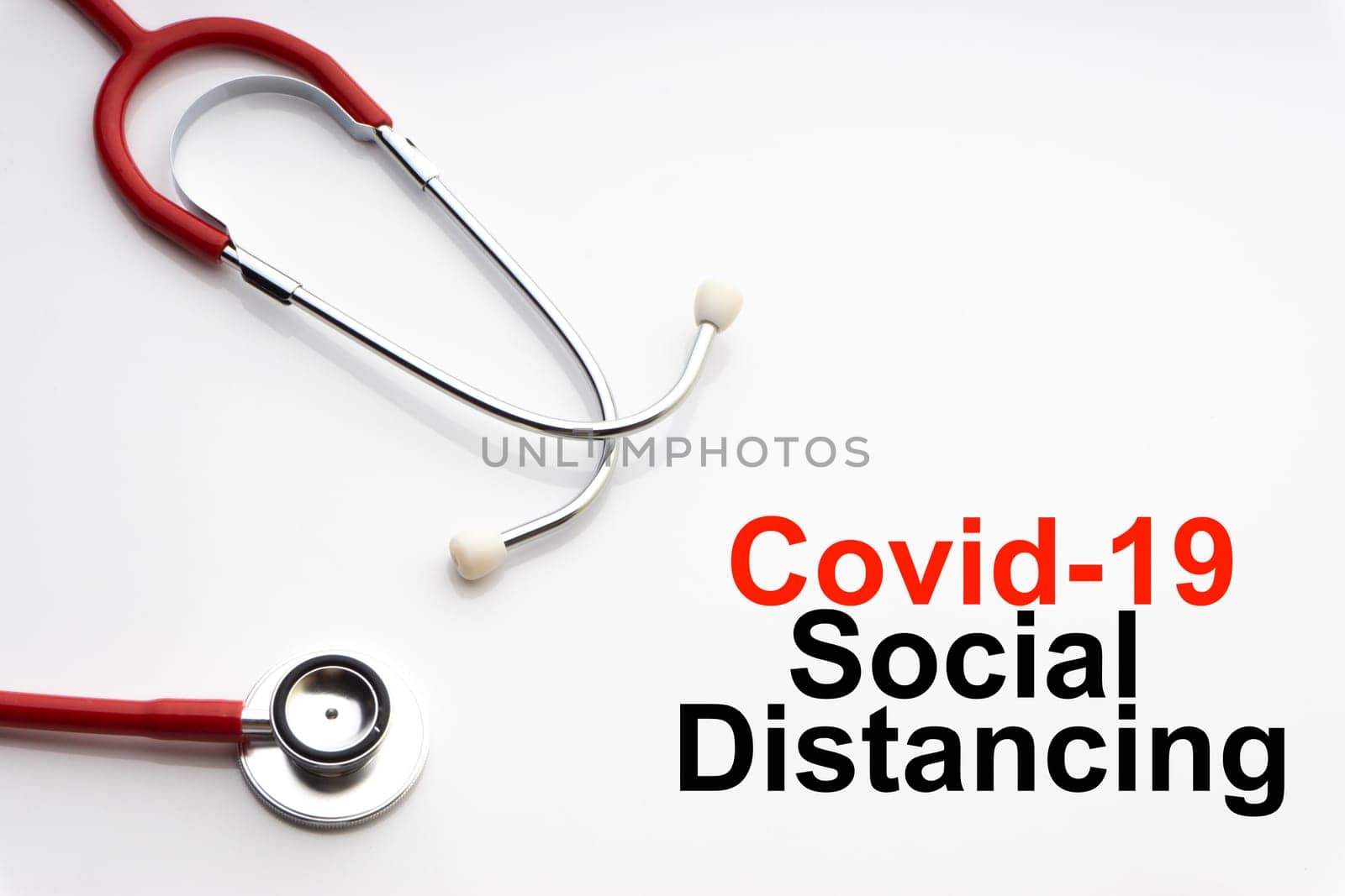 COVID-19 SOCIAL DISTANCING text with stethoscope on white background. Covid or Coronavirus Concept