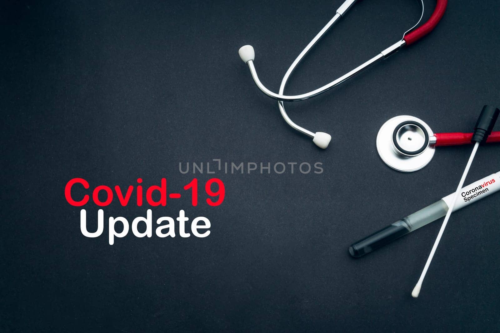COVID-19 UPDATE text with stethoscope and medical swabs on black background. Covid -19 or Coronavirus Concept