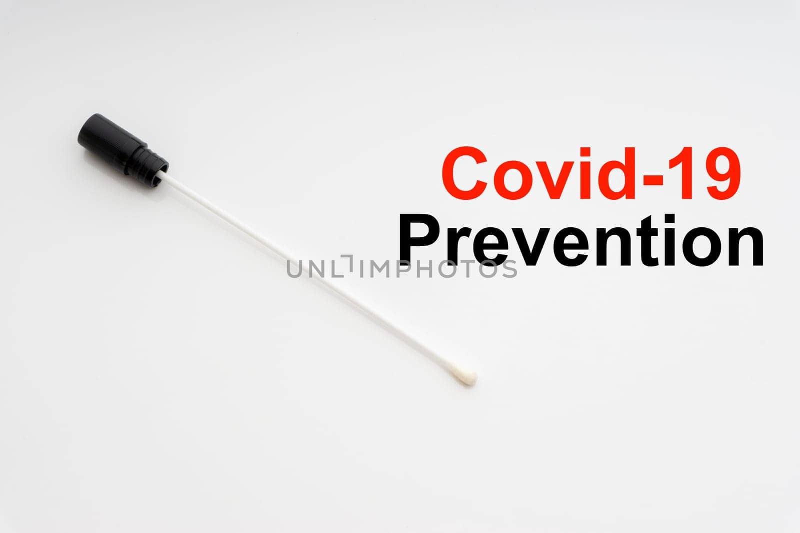 COVID-19 PREVENTION text with medical swab on white background. Covid or Coronavirus Concept