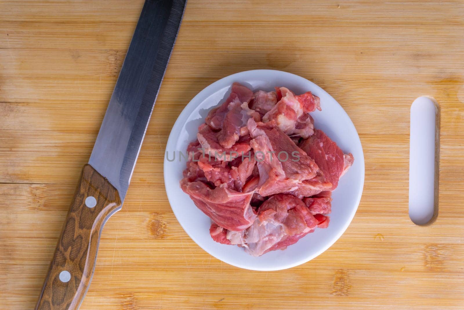 Fresh raw beef steak on wooden background with selective focus