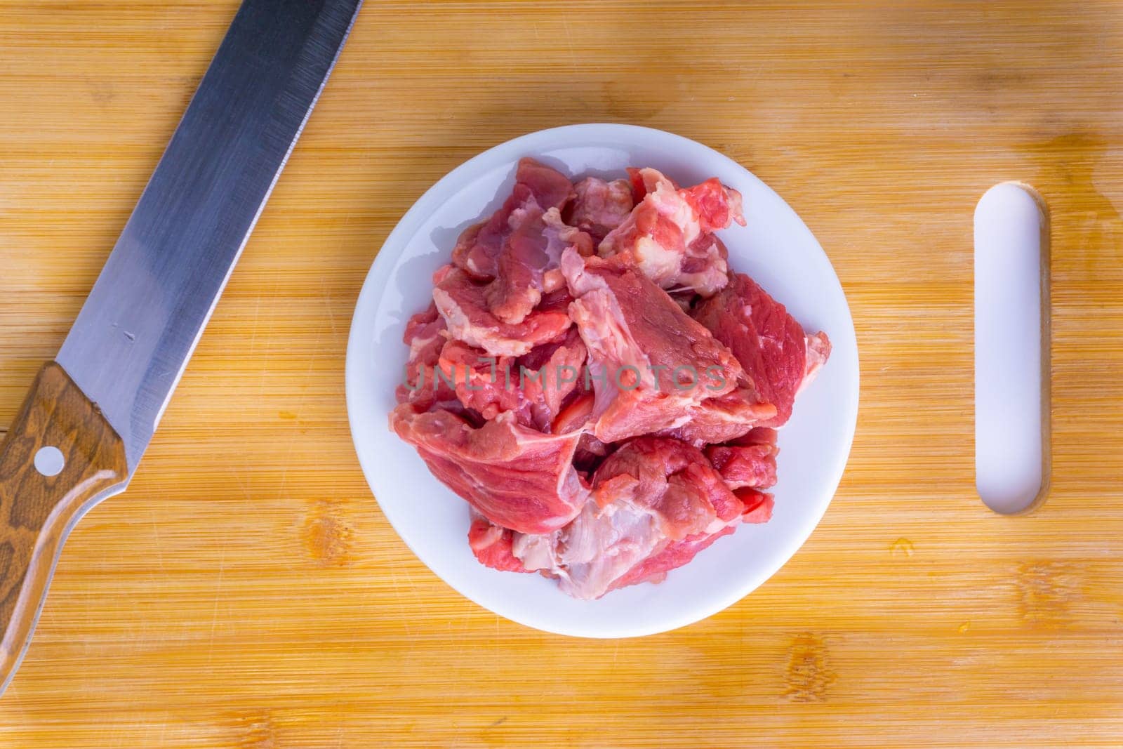 Fresh raw beef steak on wooden background with selective focus