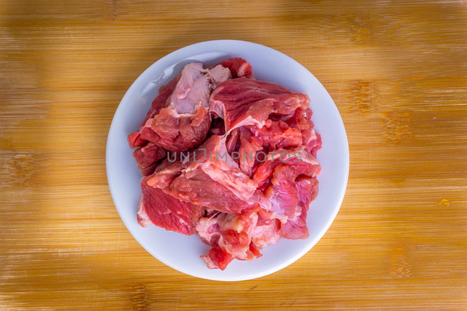 Fresh raw beef steak on wooden background with selective focus