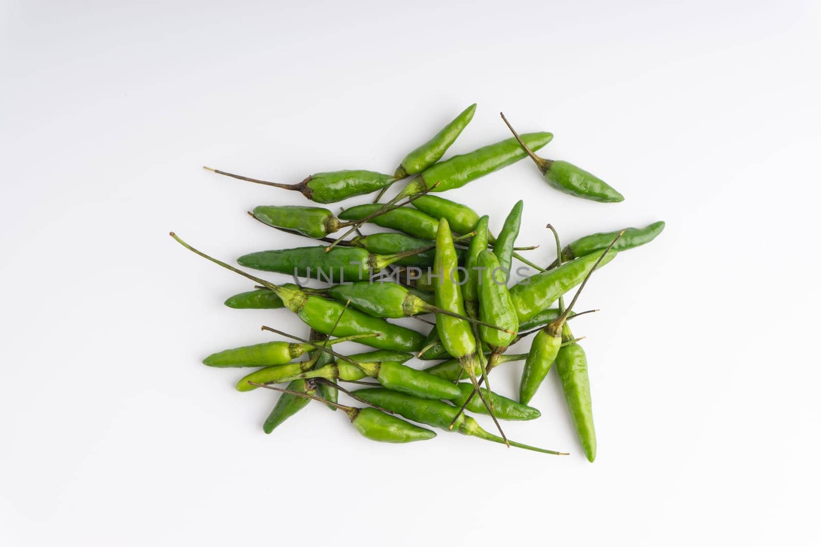 Green Bird’s eye chili,Thai Chili pepper ,bird chili pepper nature isolate on white background. Selective focus and crop fragment