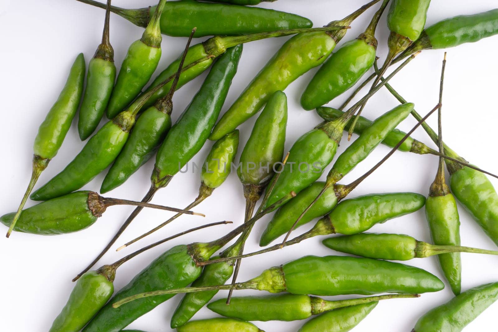 Green Bird’s eye chili,Thai Chili pepper ,bird chili pepper nature isolate on white background. Selective focus and crop fragment