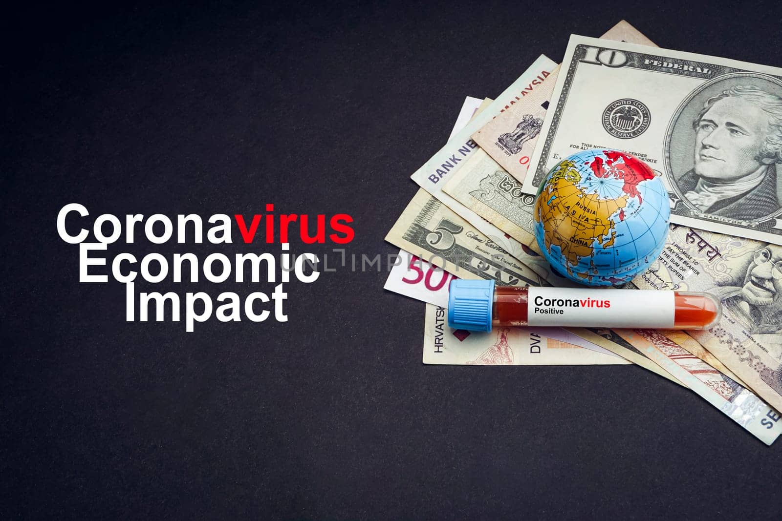 CORONAVIRUS ECONOMIC IMPACT text with currency banknotes, world globe and blood test vacuum tube on black background. Covid-19 or Coronavirus Concept