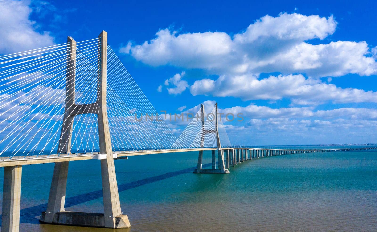Vasco da Gama Bridge in Lisbon is a famous landmark in the city - aerial drone footage