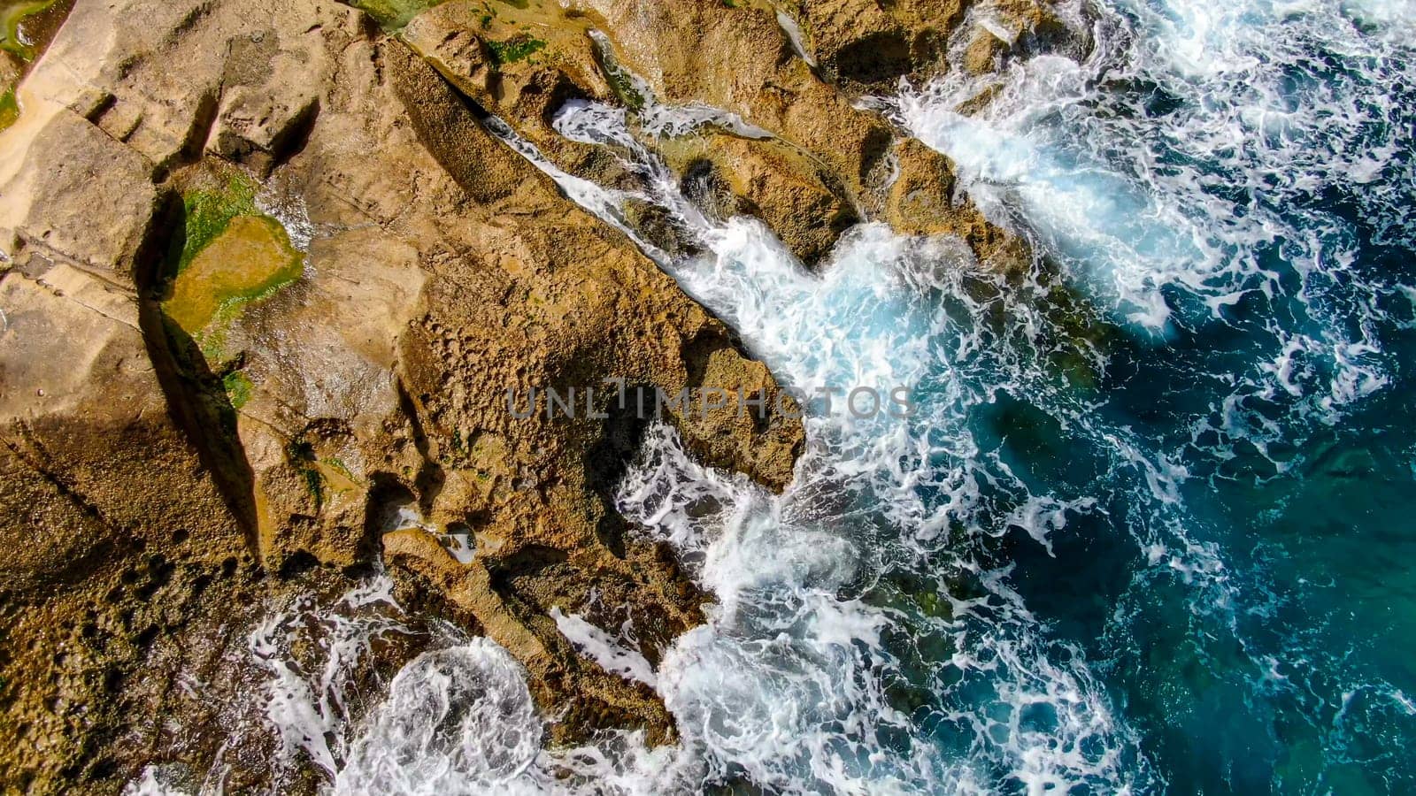 Wild Ocean water from above - Waves hitting the rocks - aerial photography