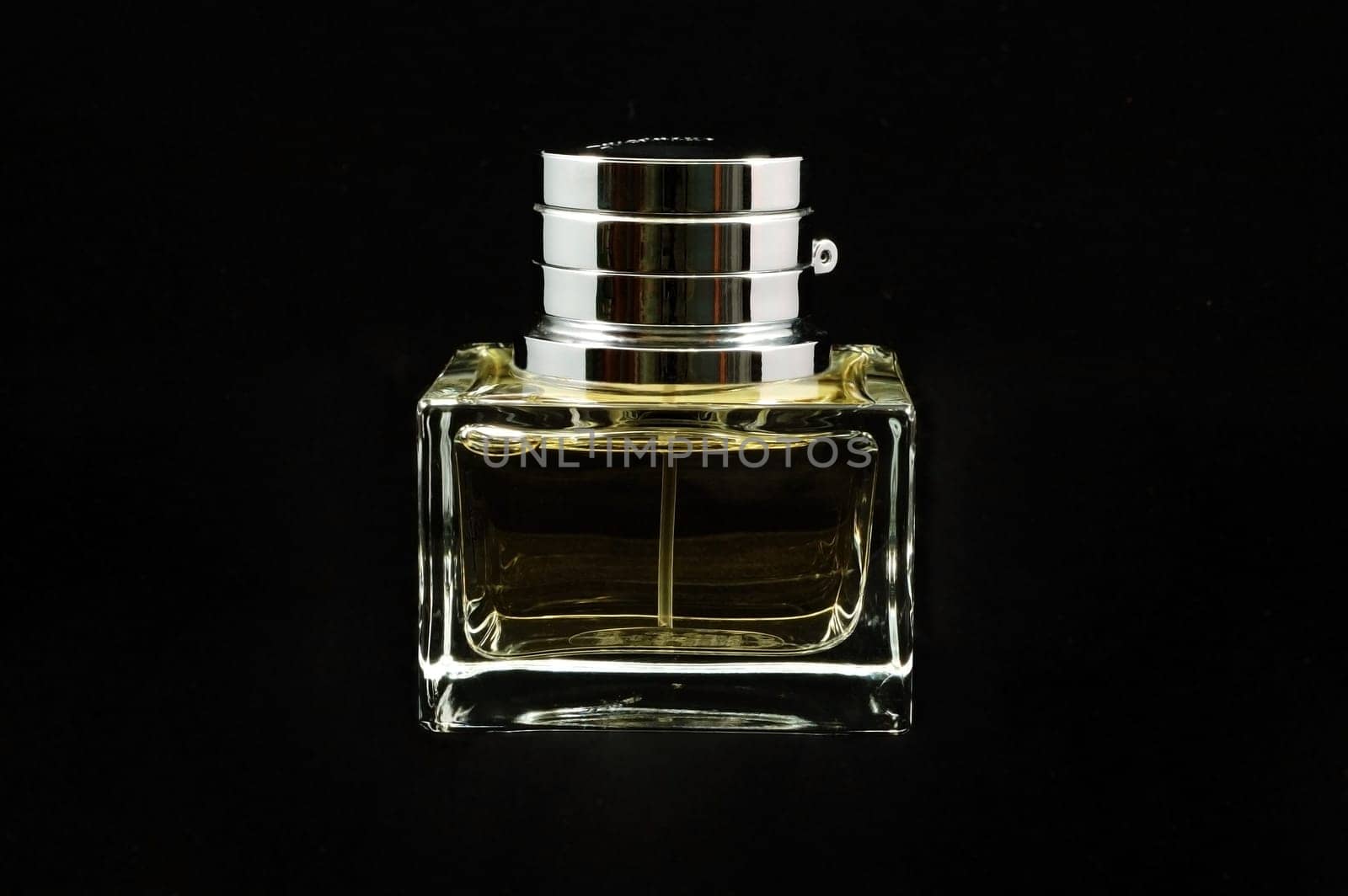 An isolated perfume bottle over black background