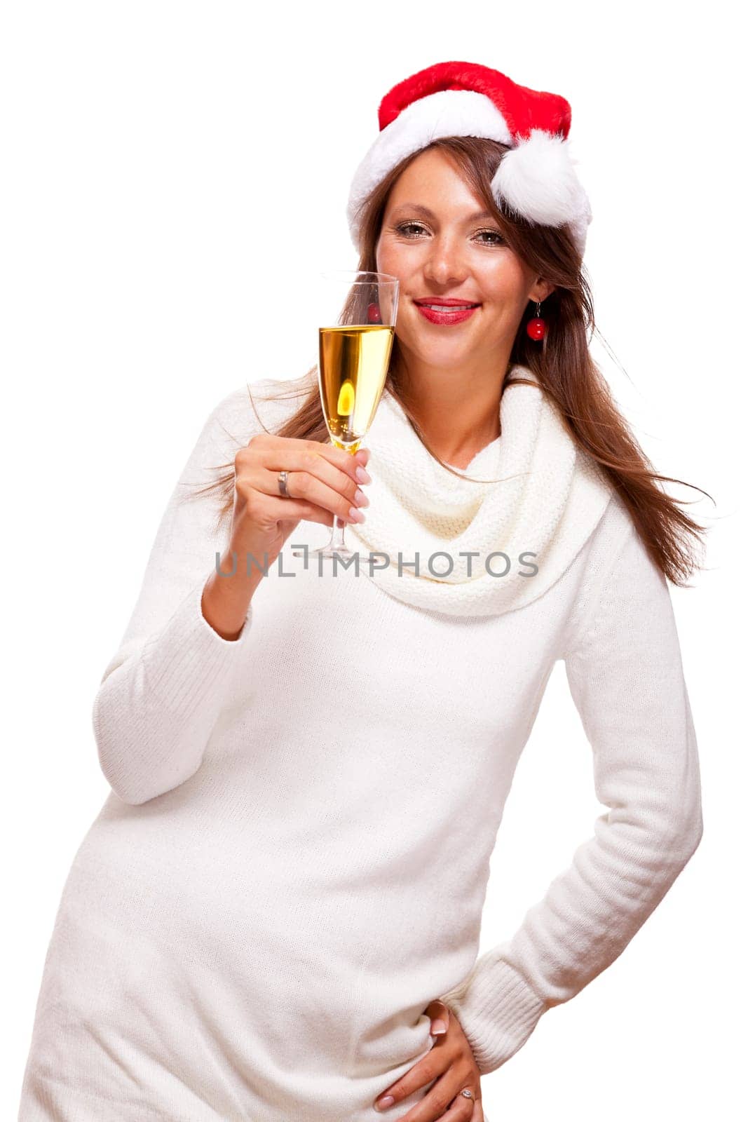 Attractive woman with red Santa hat holds a glass of champagne in her hand and smiles isolated on white background freeing text space