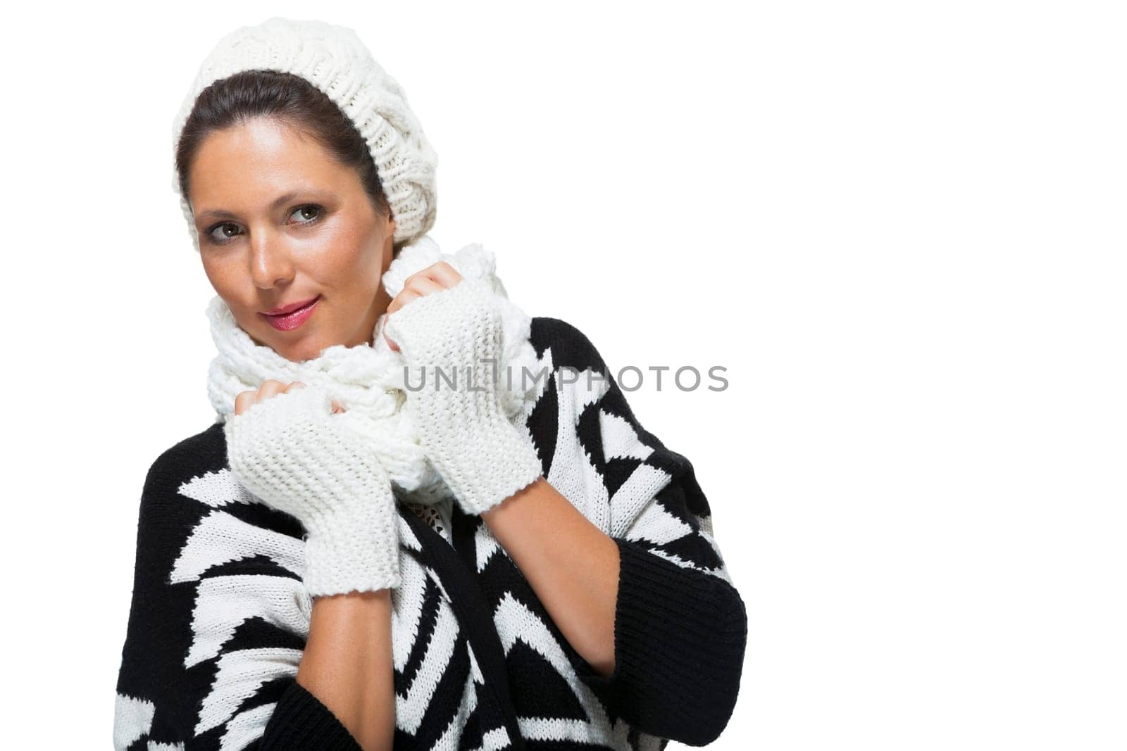 attractive young woman with white wool hat and knitted sweater scarf gloves with dark hair laughing isolated on white background