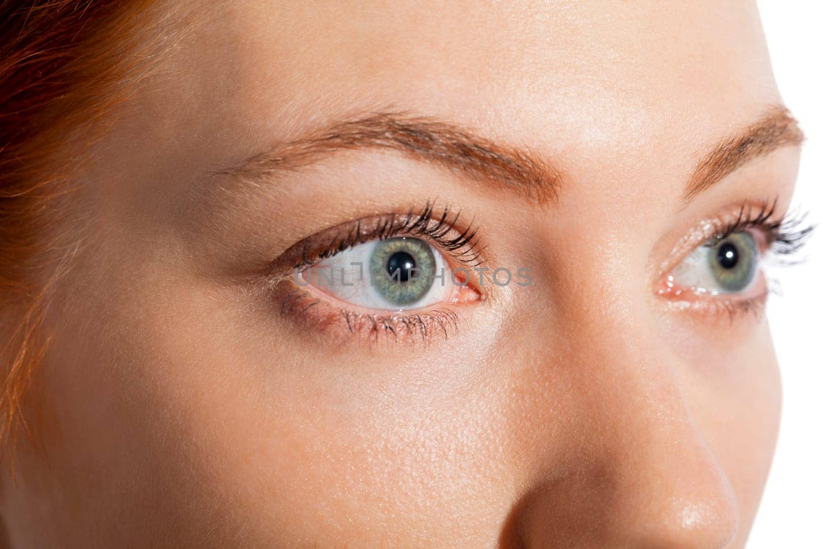 Close-up of a female face with eye lip nose and eyebrows isolated on white background