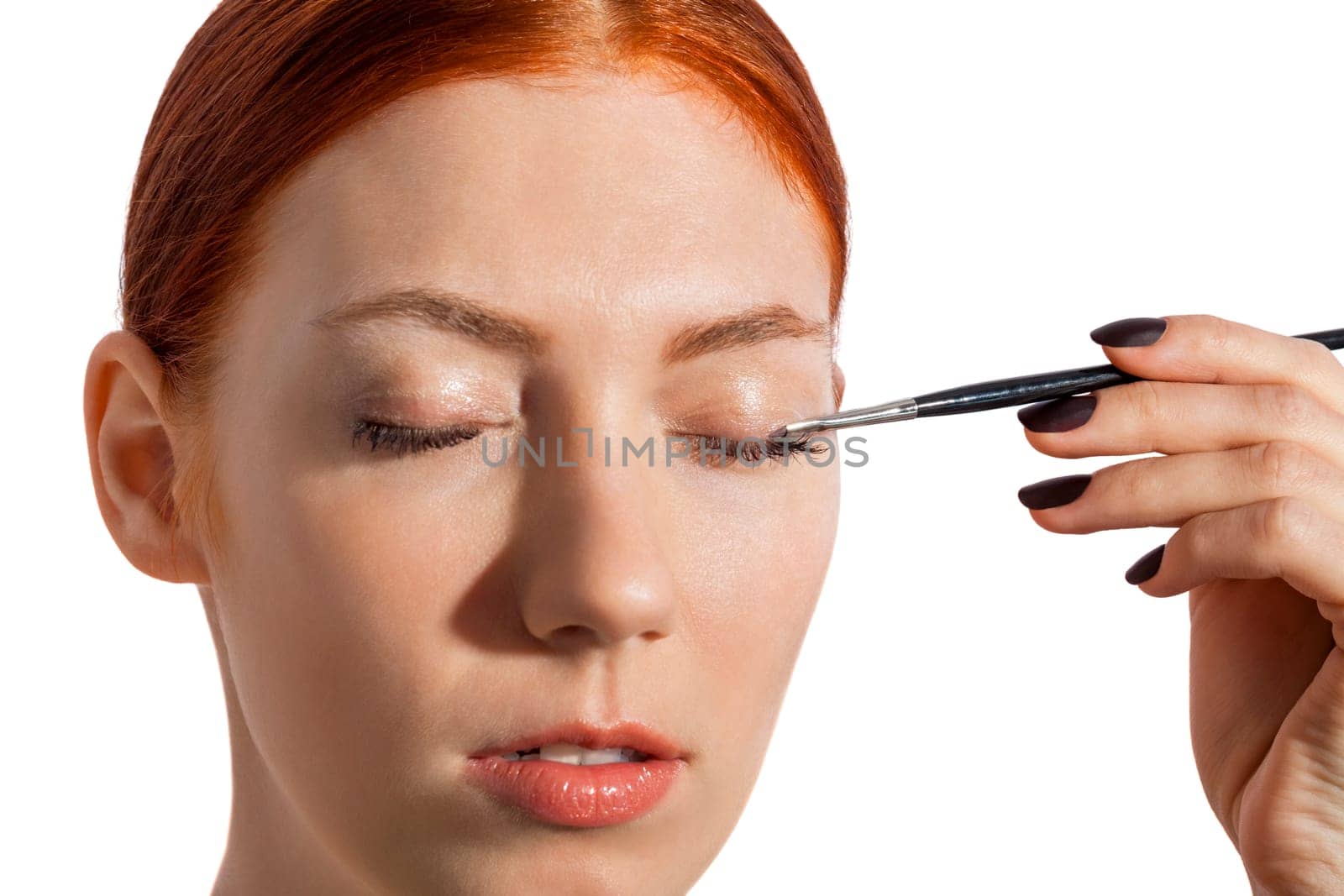 Young pretty woman with red hair wears makeup on nak shot portrait isolated against white background