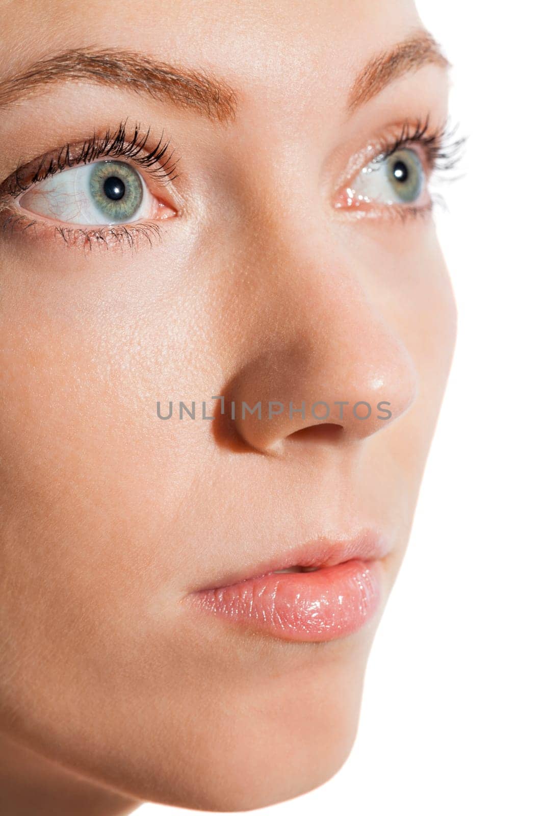 Close-up of a female face with eye lip nose and eyebrows isolated on white background