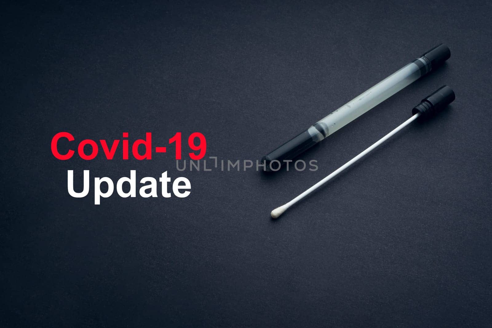 COVID-19 or CORONAVIRUS UPDATE text with medical swab on black background. Covid-19 or Coronavirus concept.