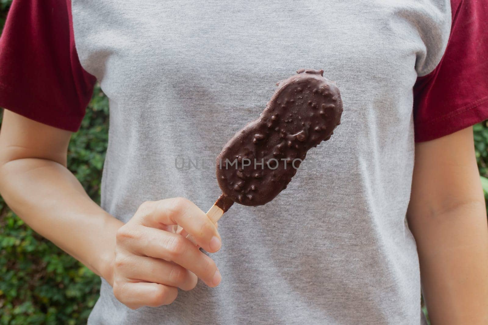 Ice cream covered with chocolate and nuts, stock photo