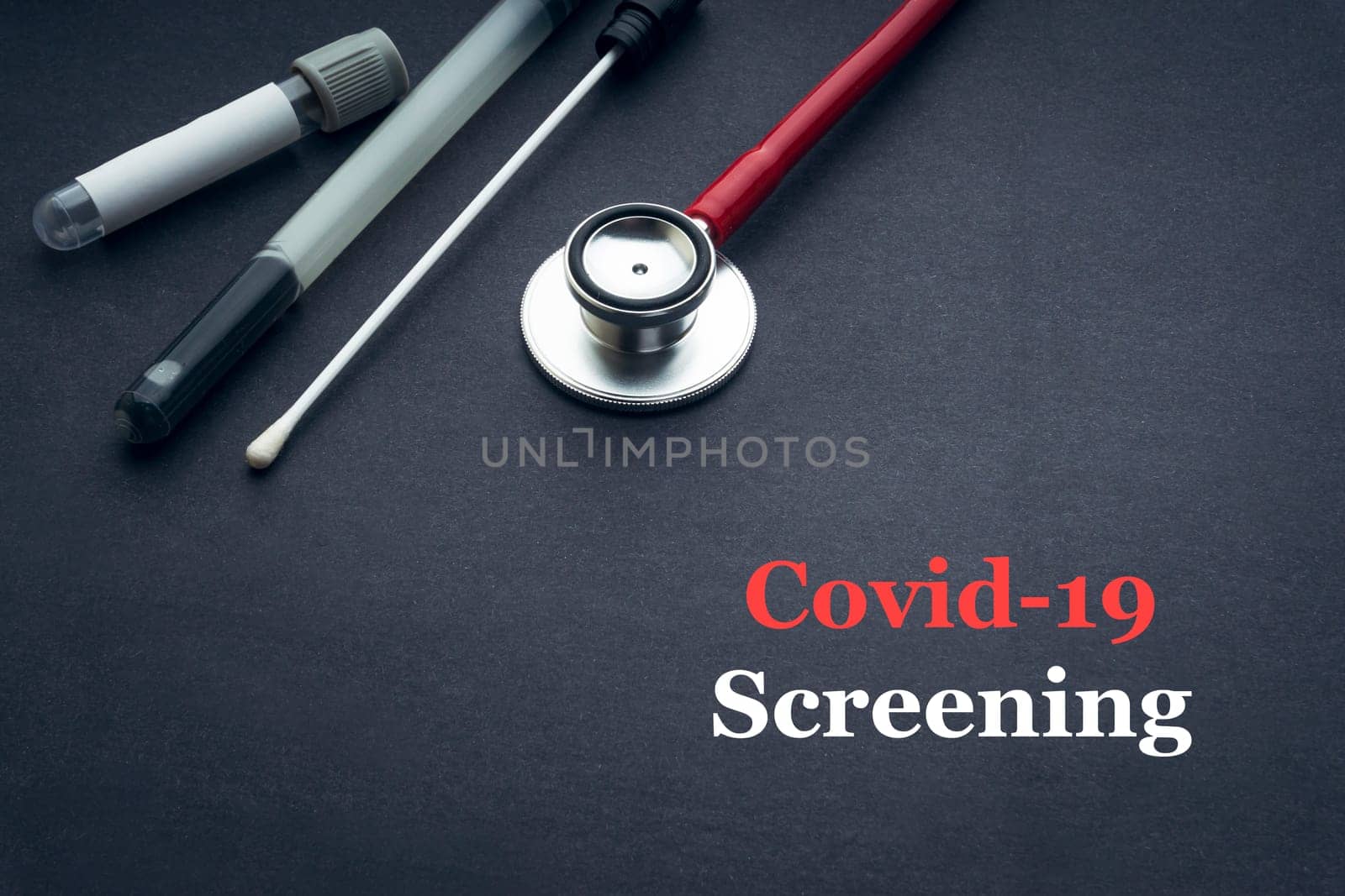 COVID-19 or CORONAVIRUS SCREENING text with stethoscope, medical swab and blood sample tube on black background. Covid-19 or Coronavirus concept.