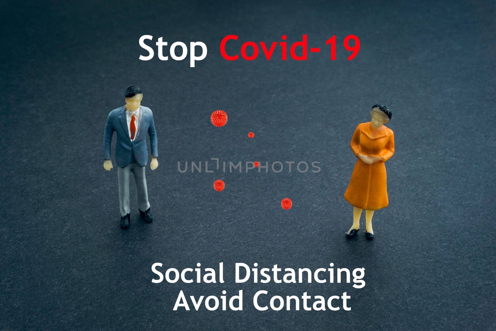 STOP COVID-19 SOCIAL DISTANCING AVOID CONTACT text with miniature people on dark background. Covid-19 or Coronavirus concept