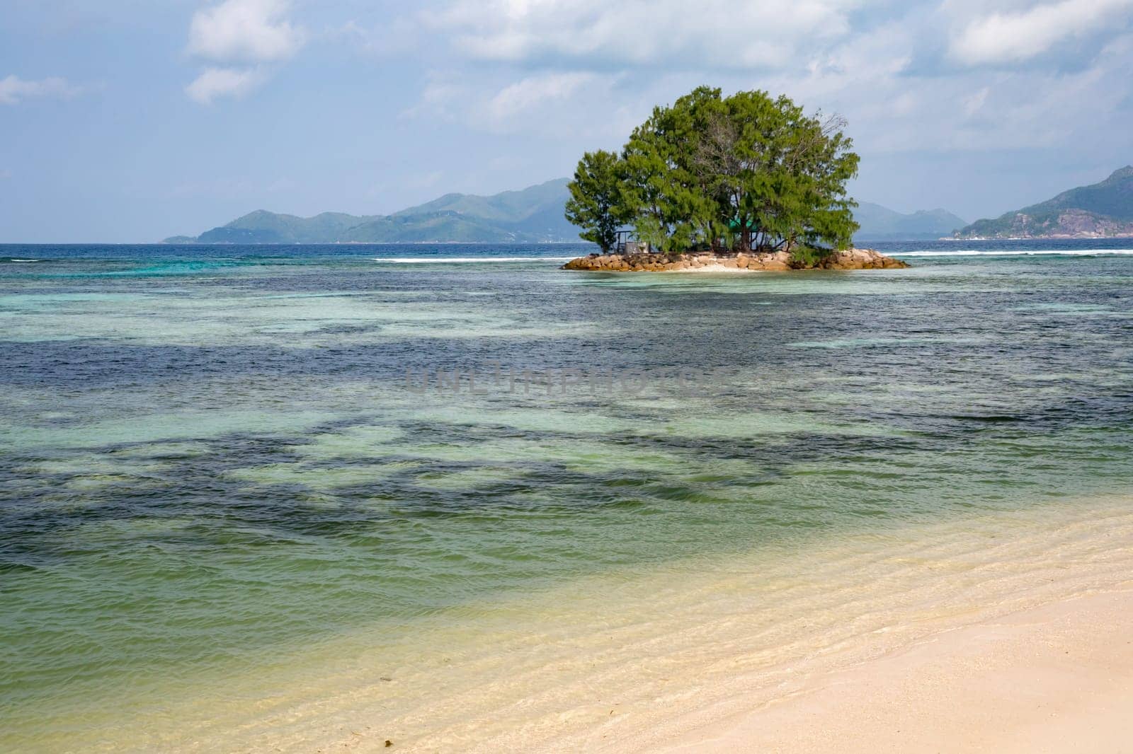 View from the main island to an another island in the near with a lot of plants and blue sky