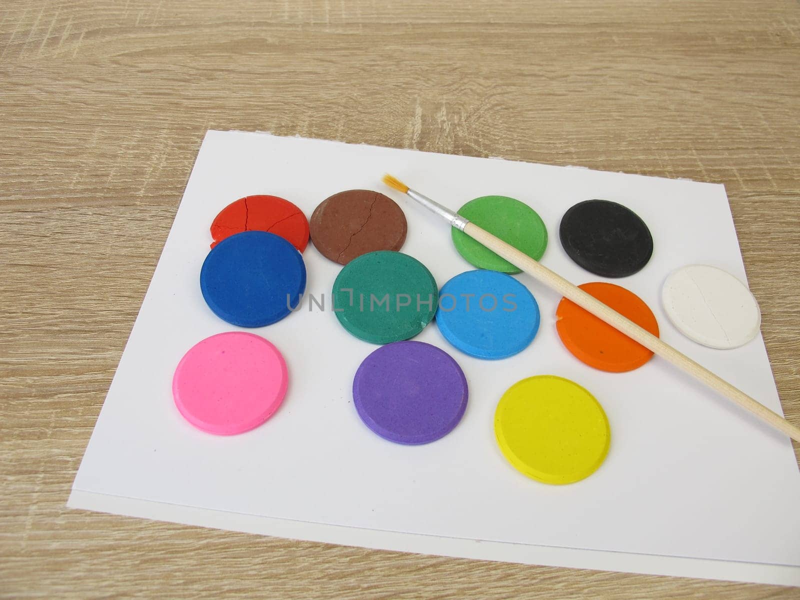 Water-soluble watercolor color tablets - Colorful watercolor, a drawing pad and a brush