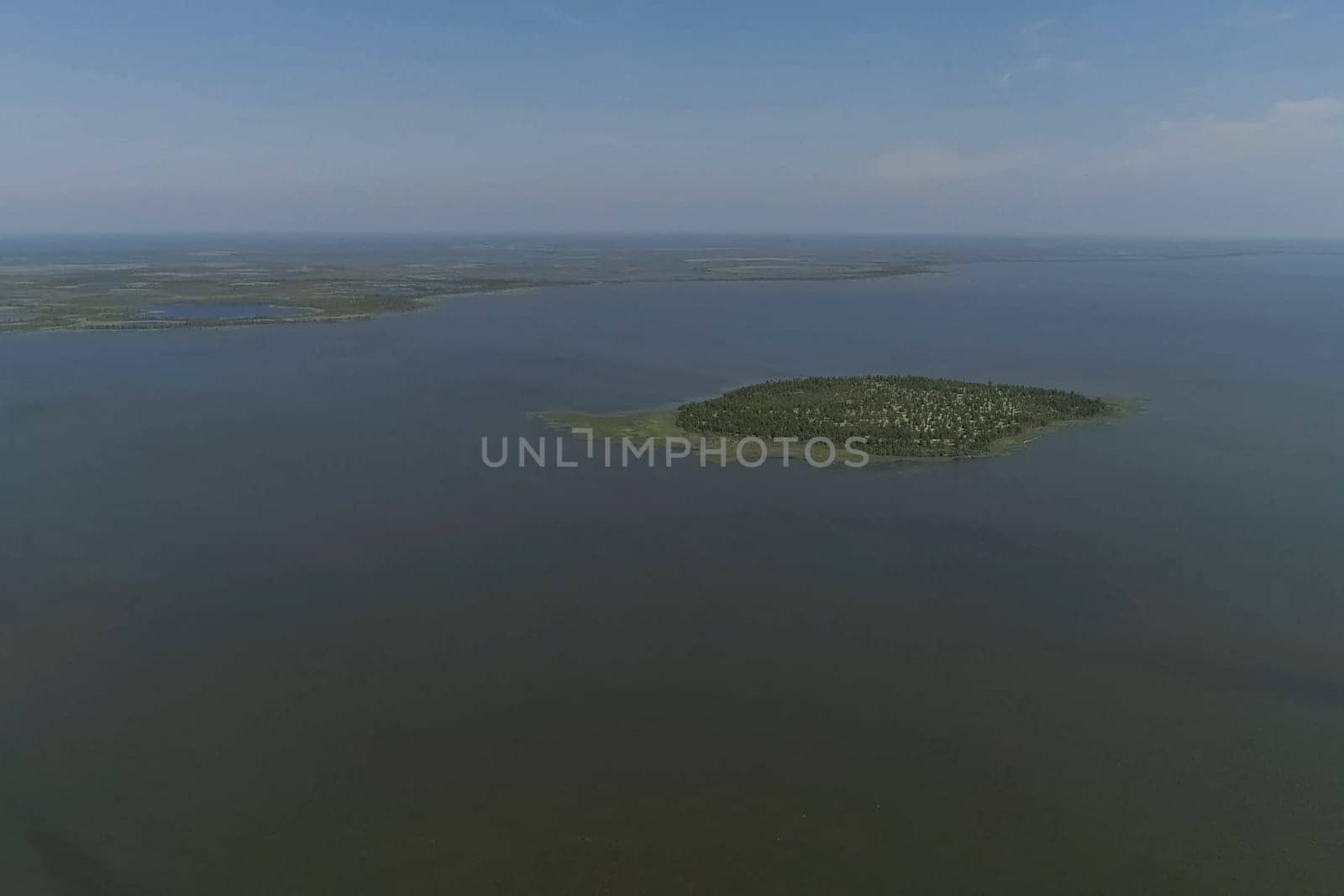 View from above on the coastal forest tundra. River and islands with taiga.