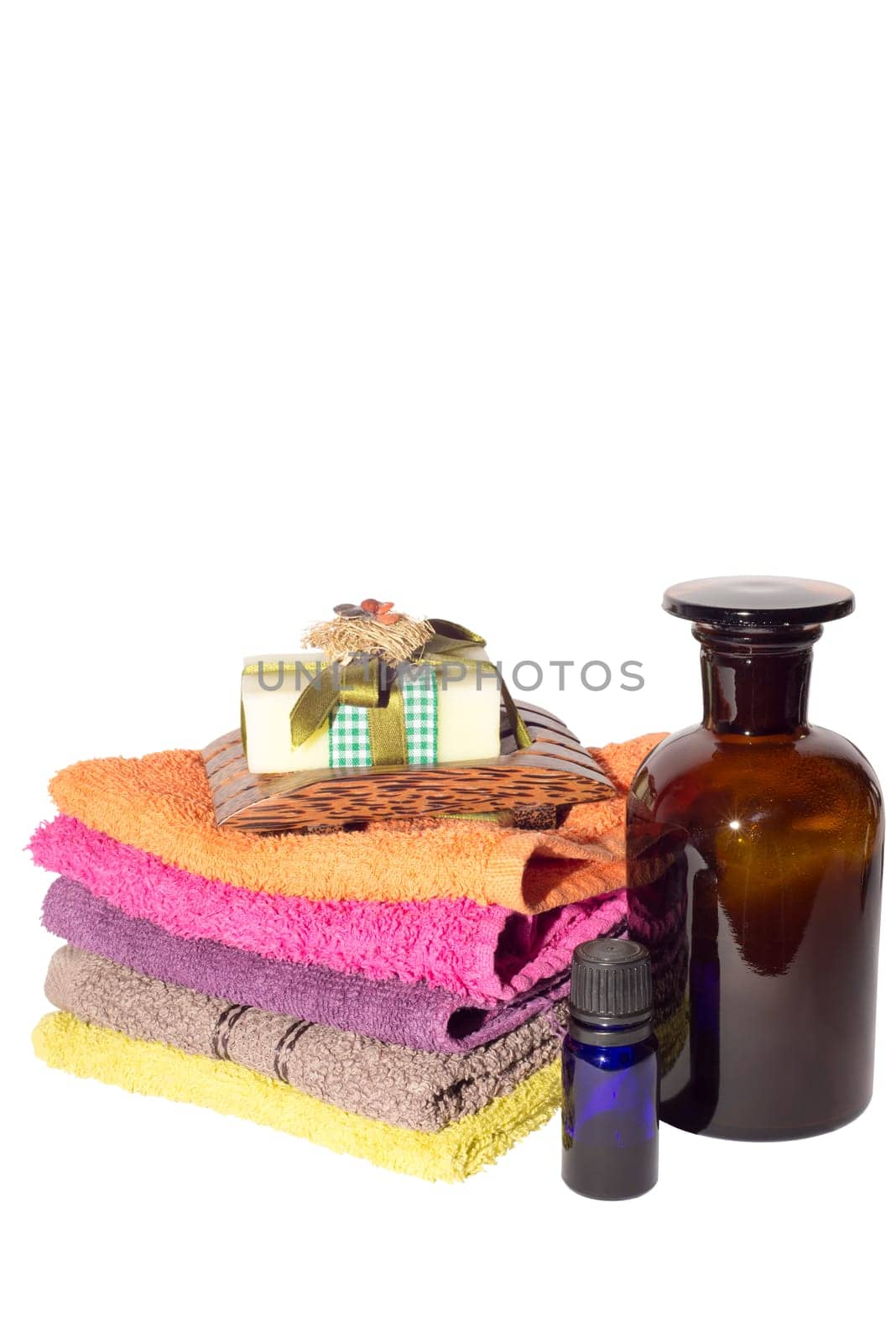 soap on top of facecloths of various shades with bottles