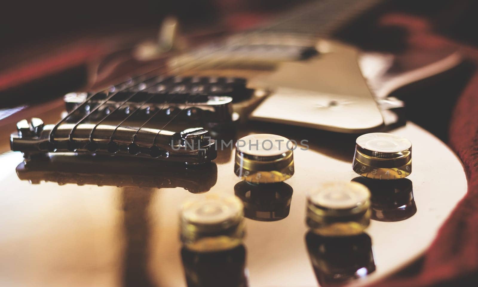 Close-up of an electric guitar laying inside a guitar case. Retro style photo.