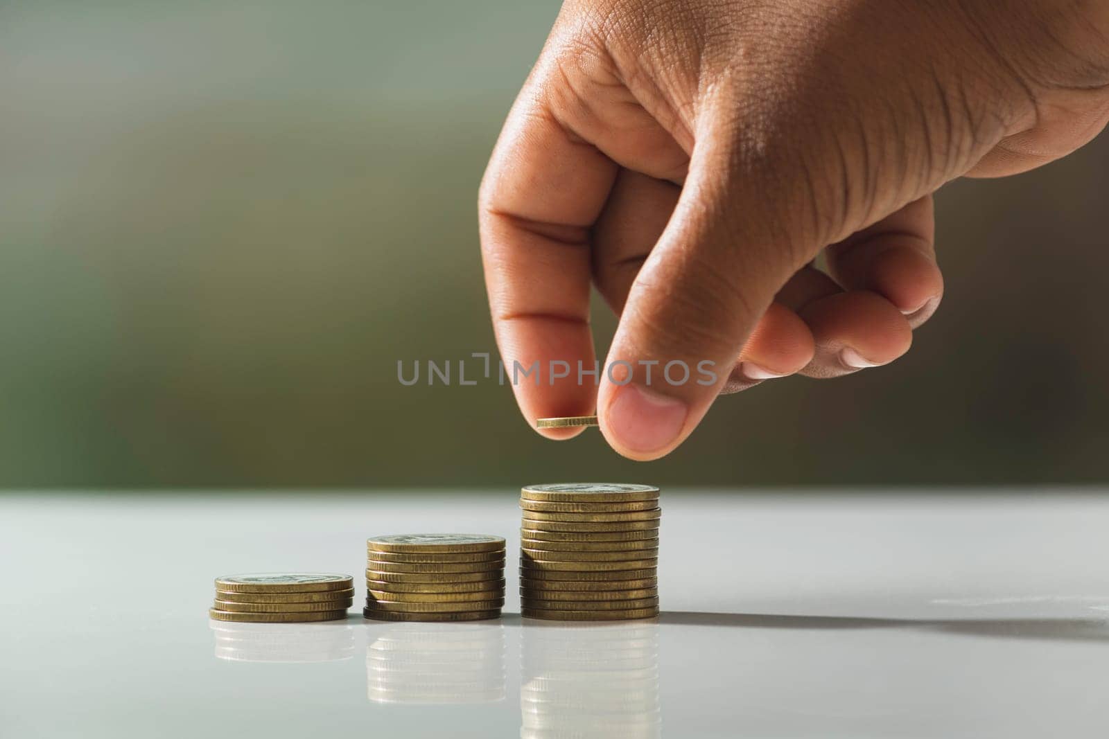 Hand drop a coin with money coin stack growing for business. financial and accounting concept.