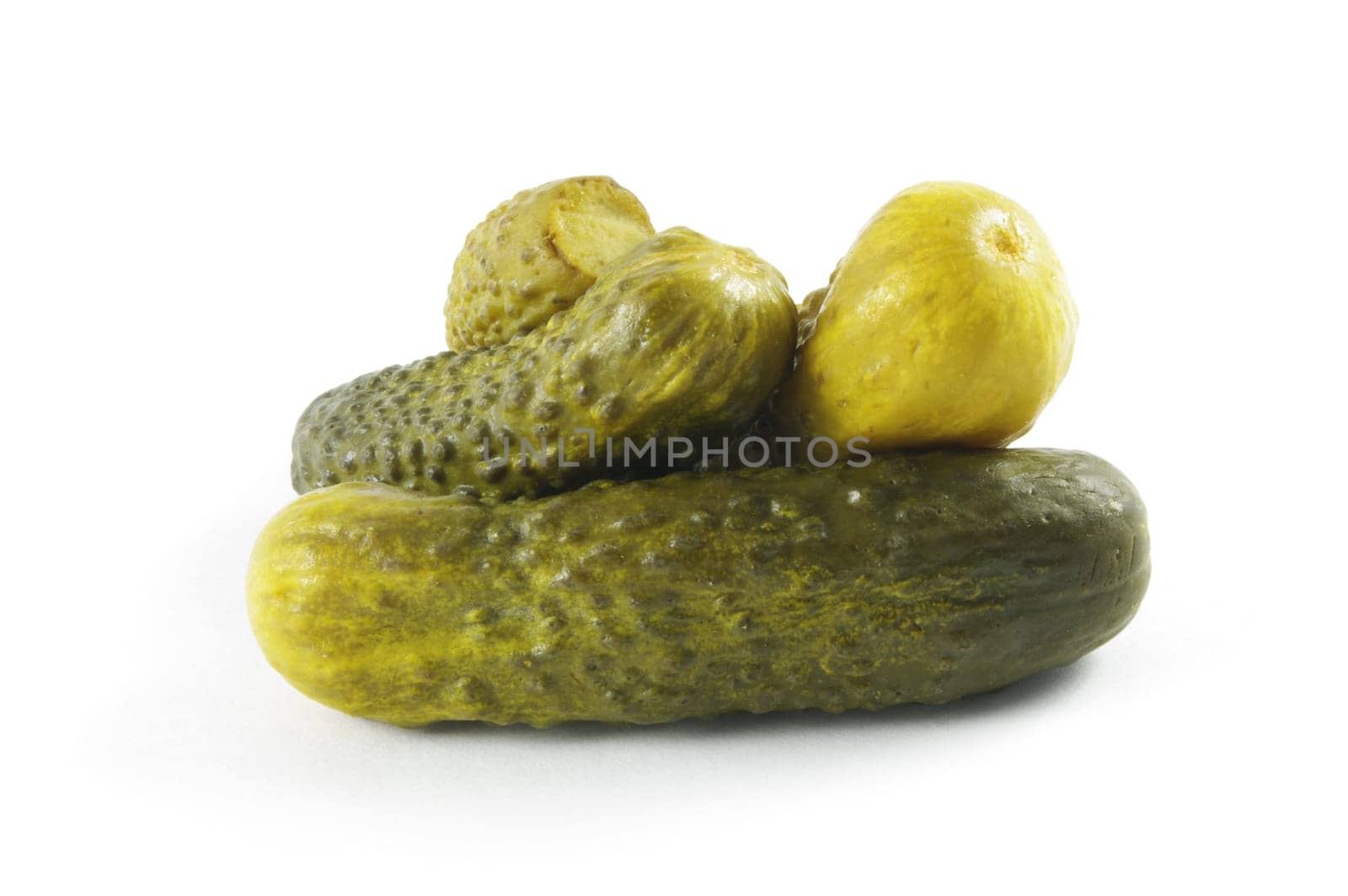 small tasty pickles in brine over white surface