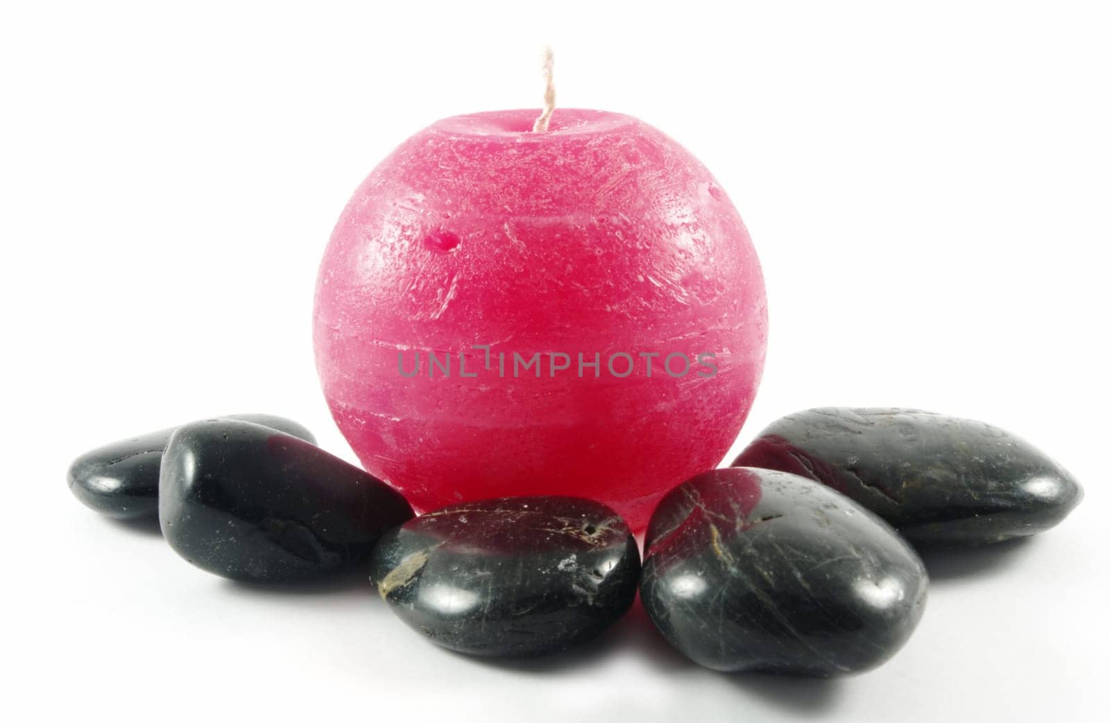 red candle with stones