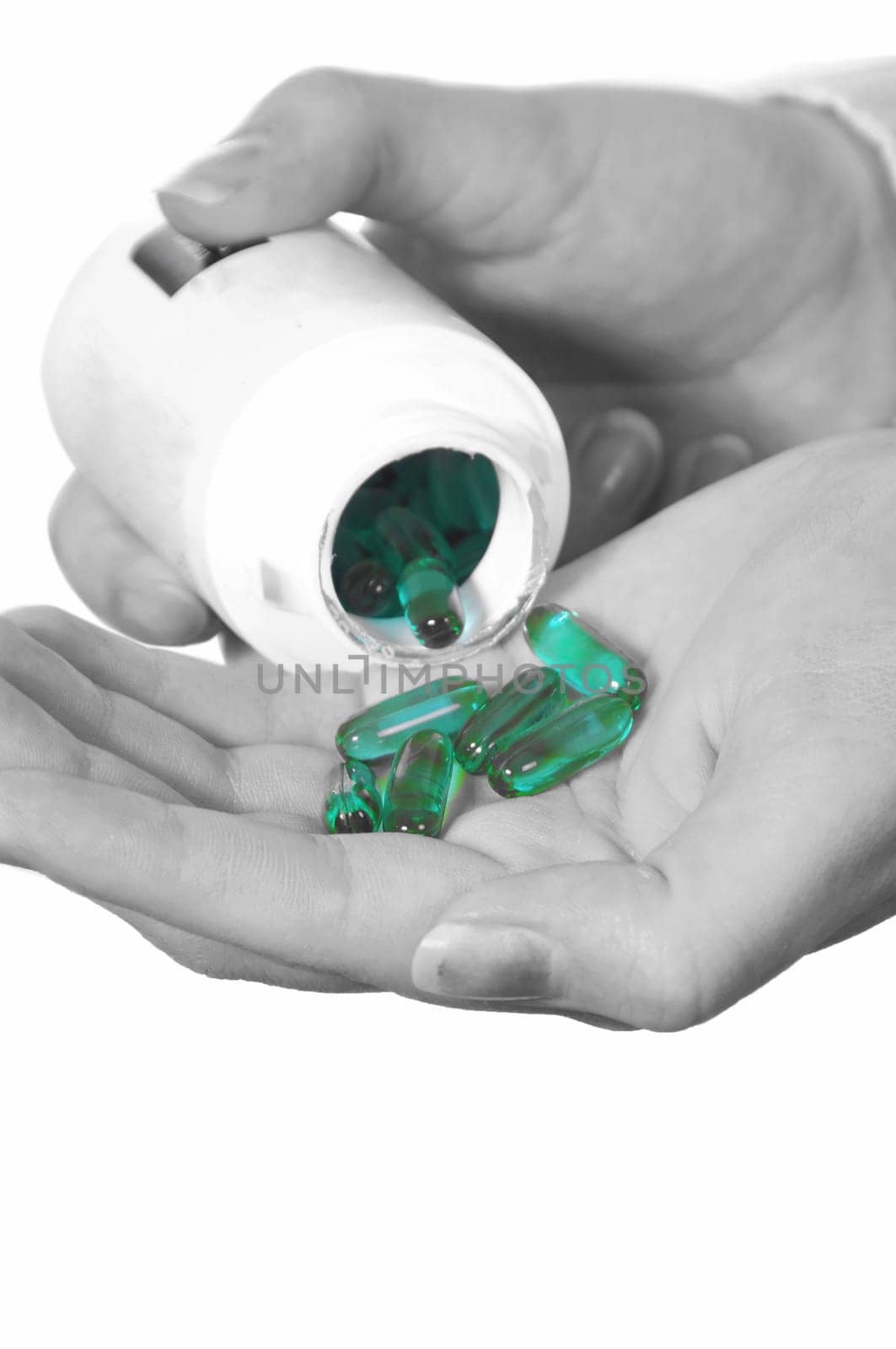 female hand with medicine pills on white.selective color