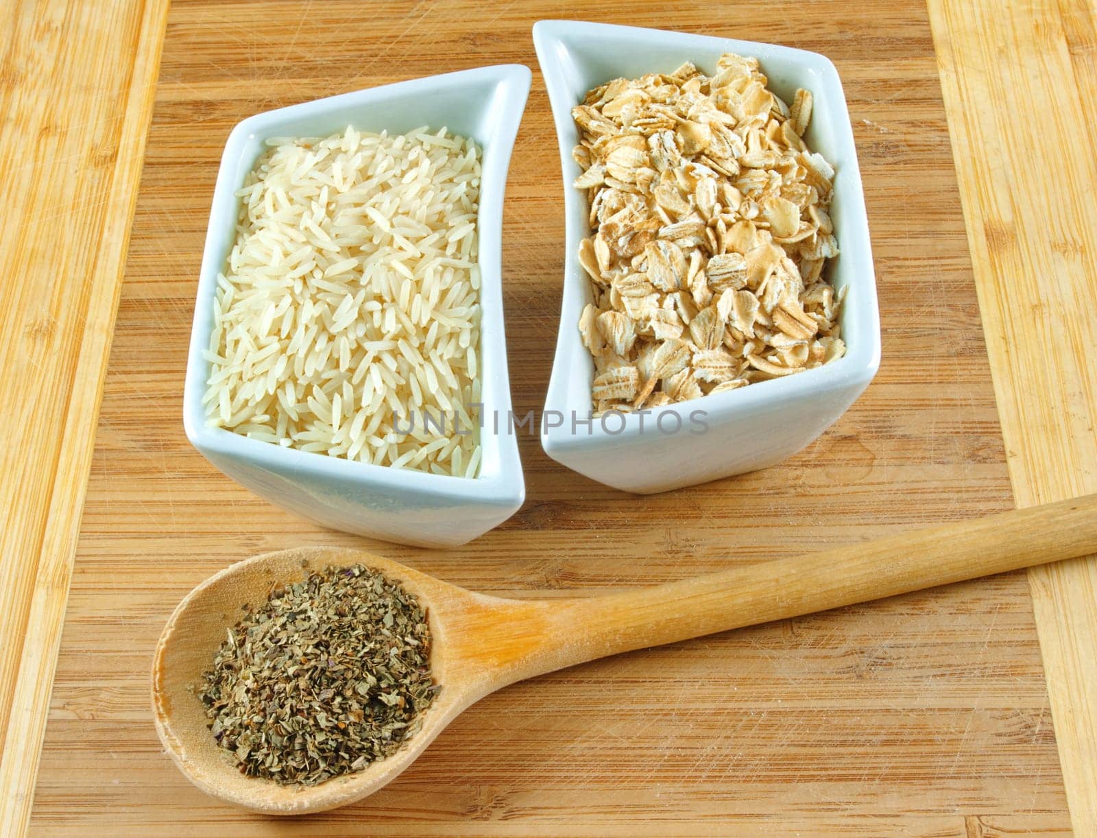 rice, oats and herbs on the wooden board