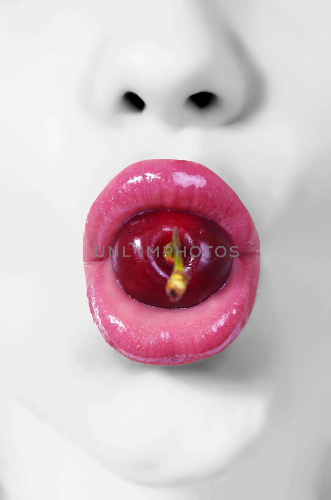 creative picture of woman's lips with cherry