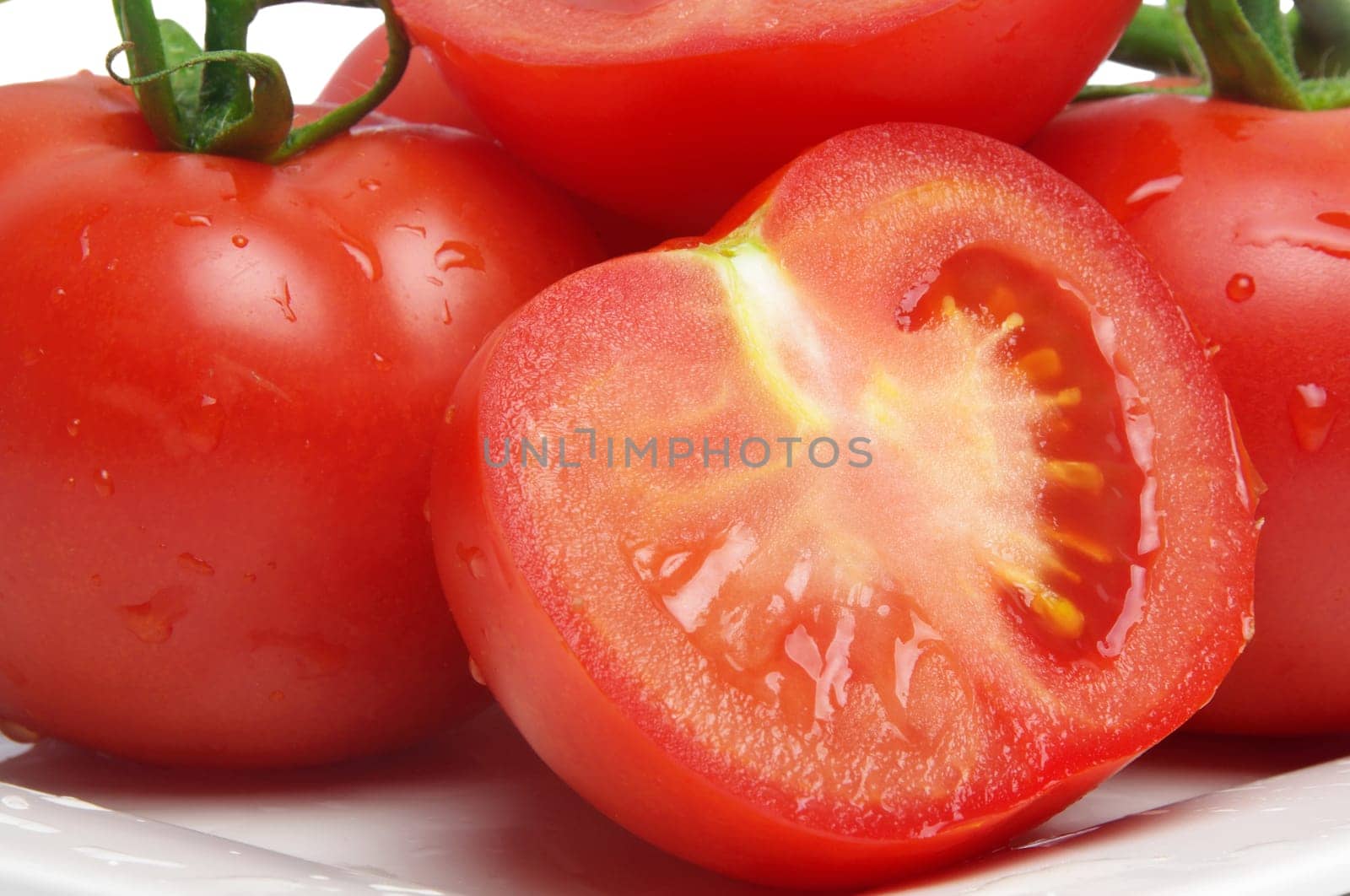 wet tomatoes closeup on plate