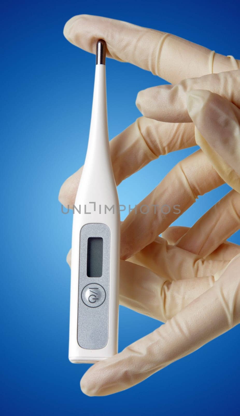 hand with medical gloves and thermometer on blue surface