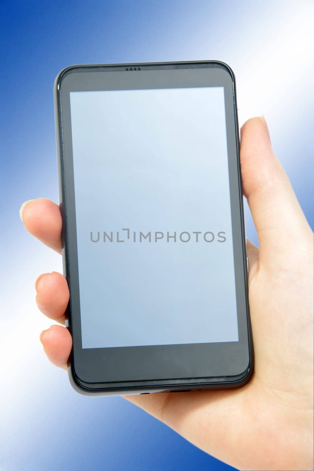 modern smartphone in female hand on blue