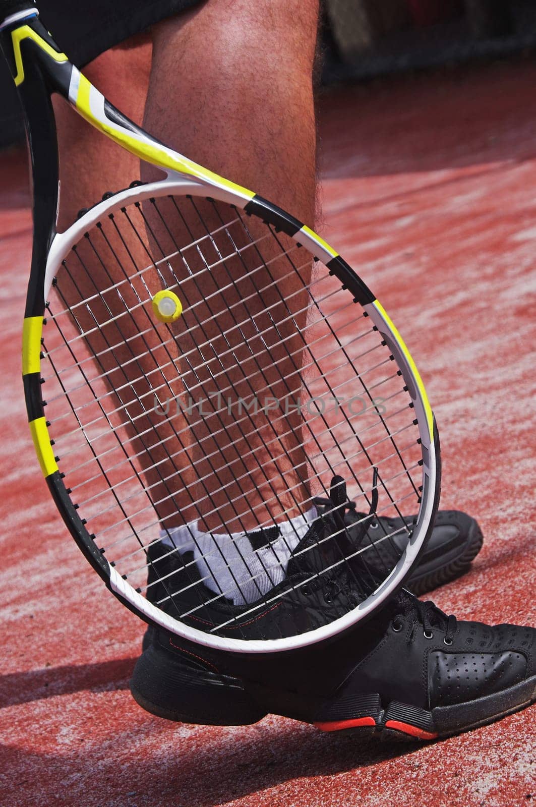 tennis player legs with racket
