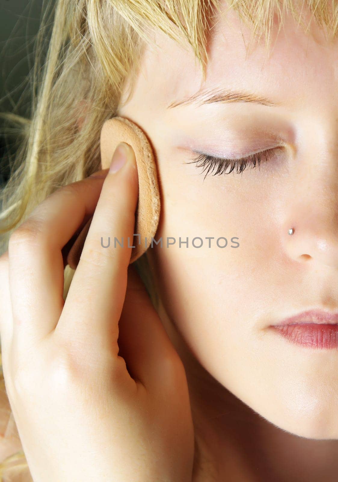 closeup of woman doing facial treatments