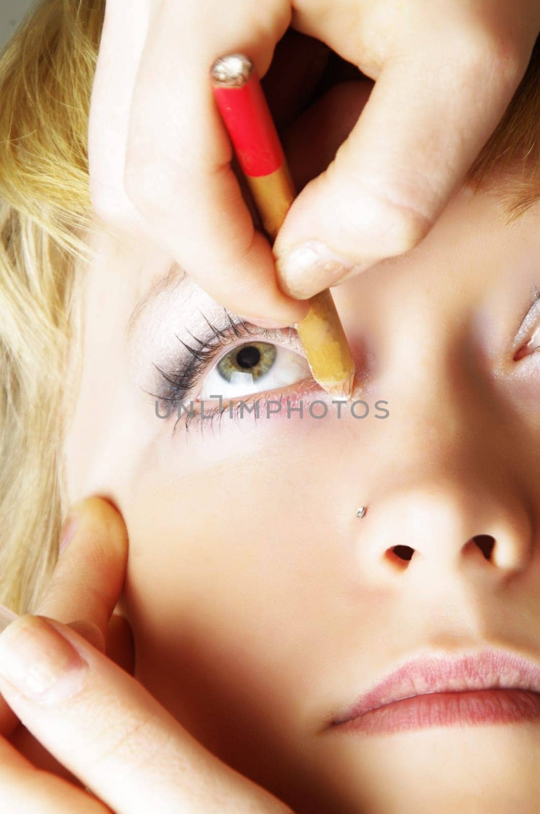 closeup of woman doing eyes treatments
