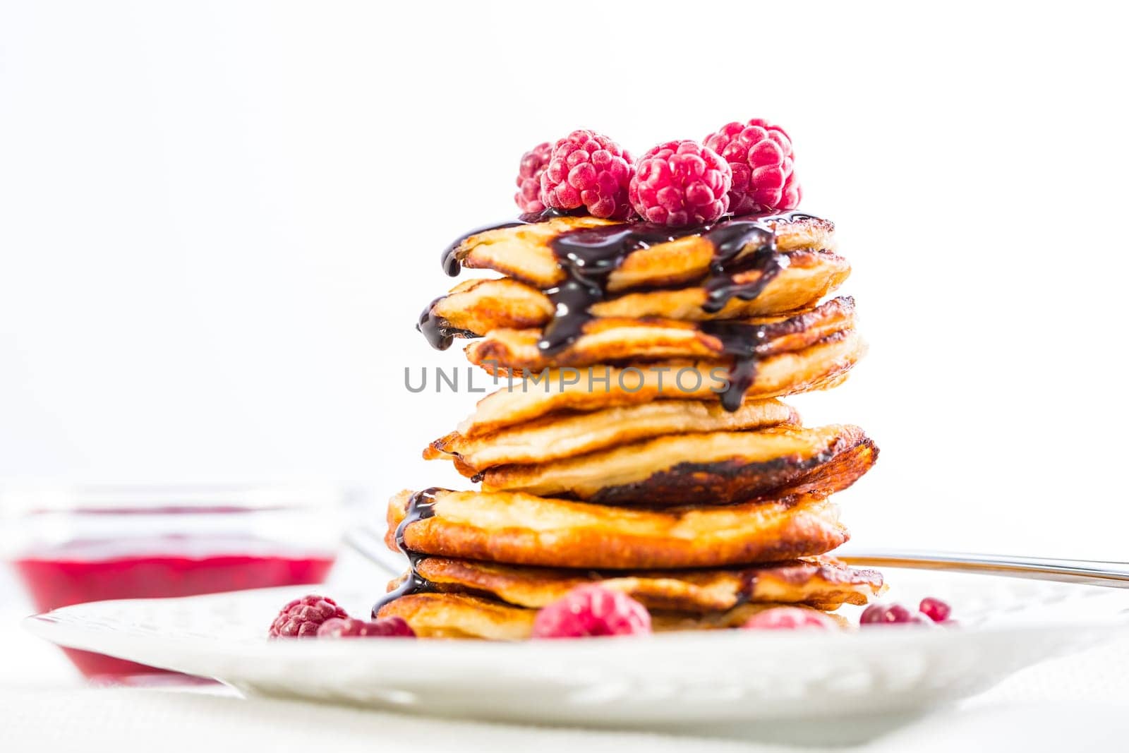 Delicious cottage cheese pancakes with fresh raspberry and chocolate sirup. Curd fritters.