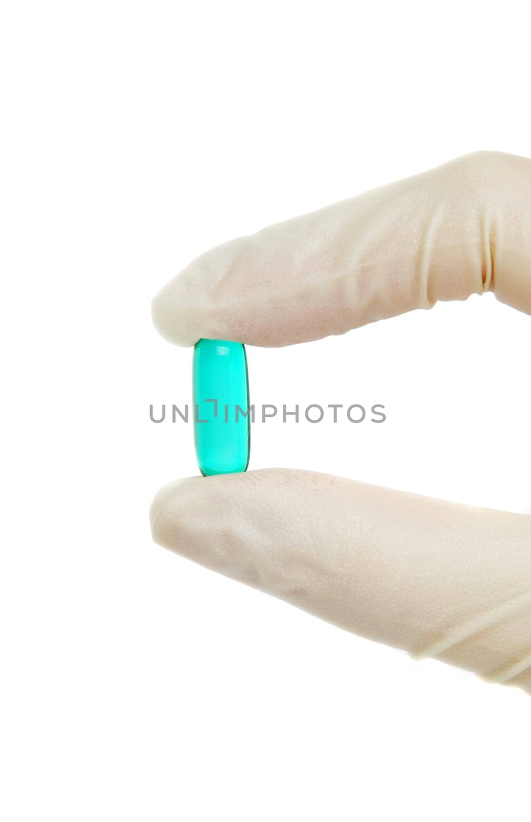 blue pill in hand with medical gloves