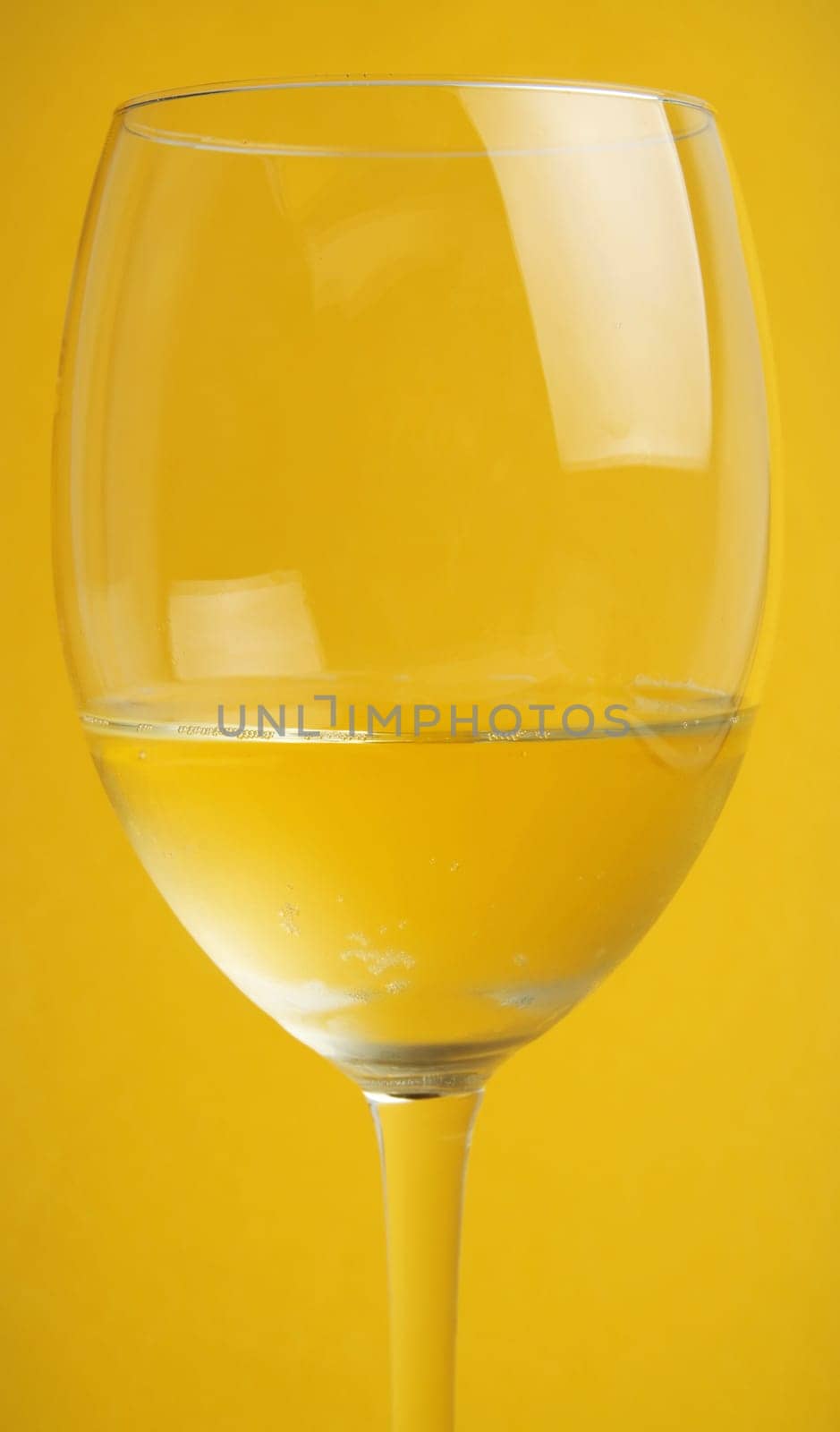 glass of wine on the yellow background