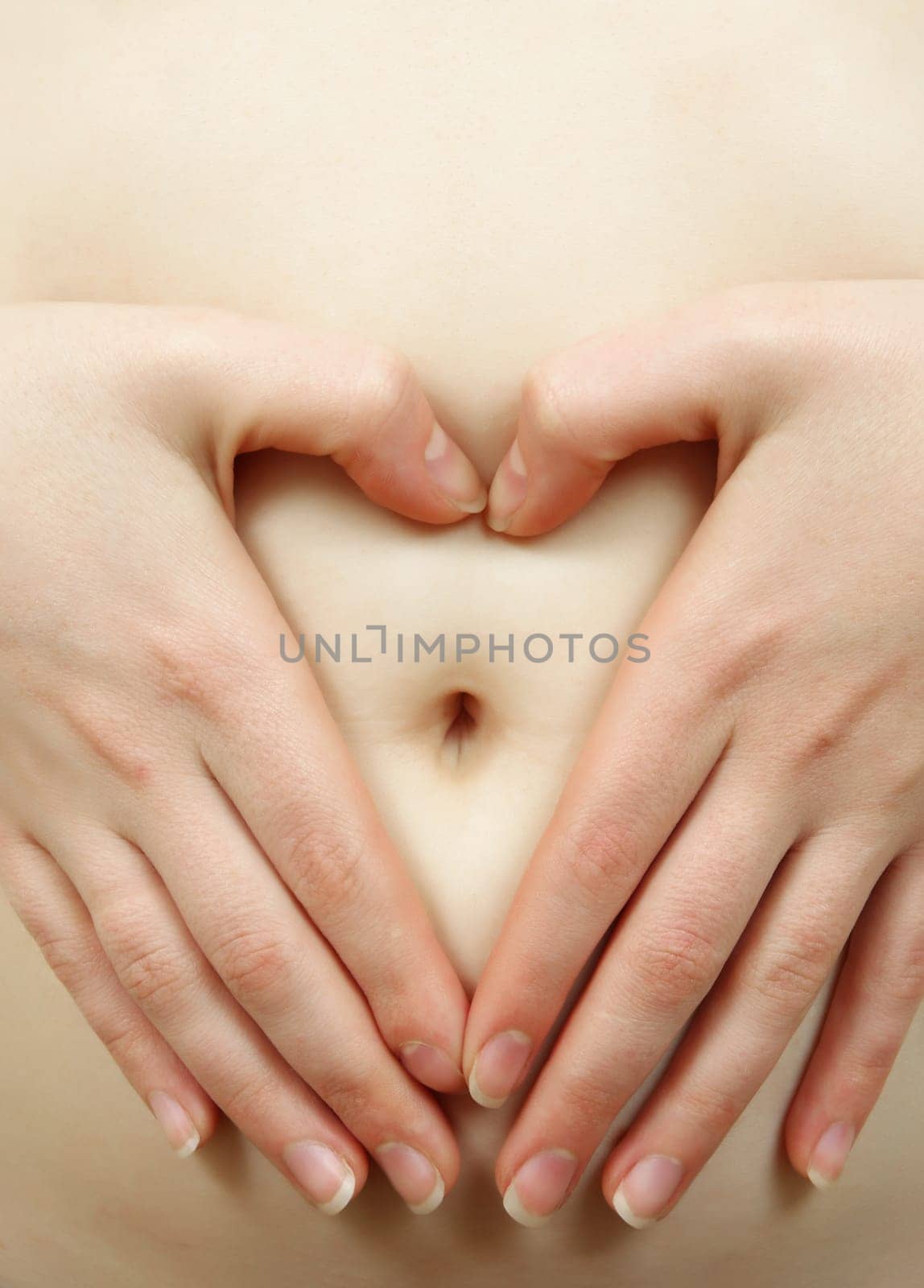 female hands on bare belly