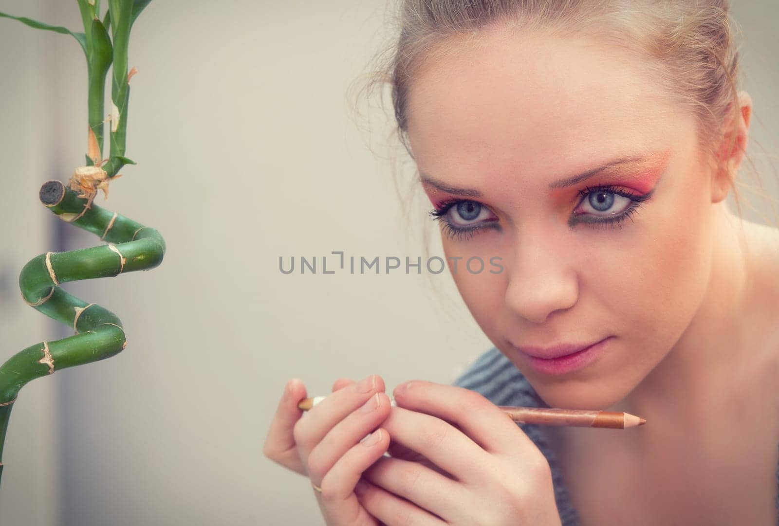 woman applying make up in front of mirror