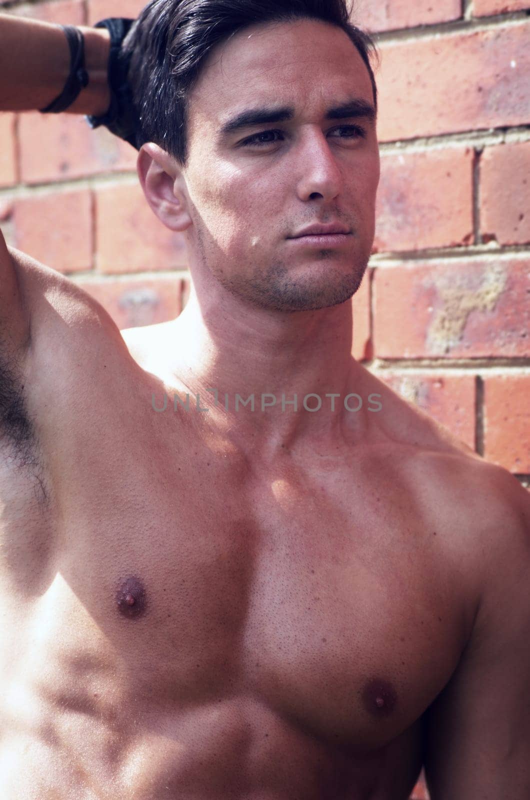 portrait of shirtless man outdoors