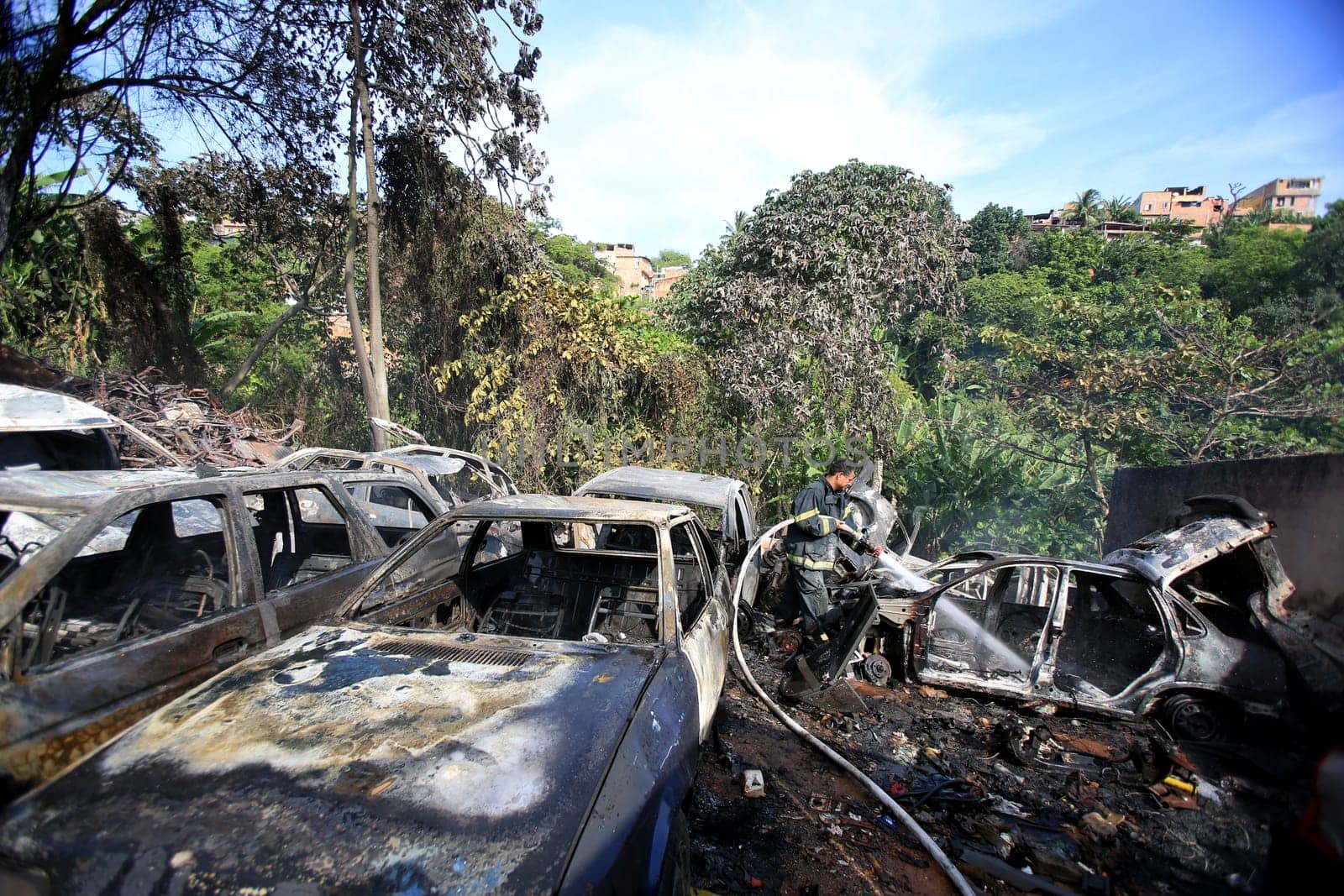 salvador, bahia / brazil - january 25, 2016: members of the fire brigade are seen during the aftermath in a vehicle fire in the Lobato neighborhood in the city of Salvador..